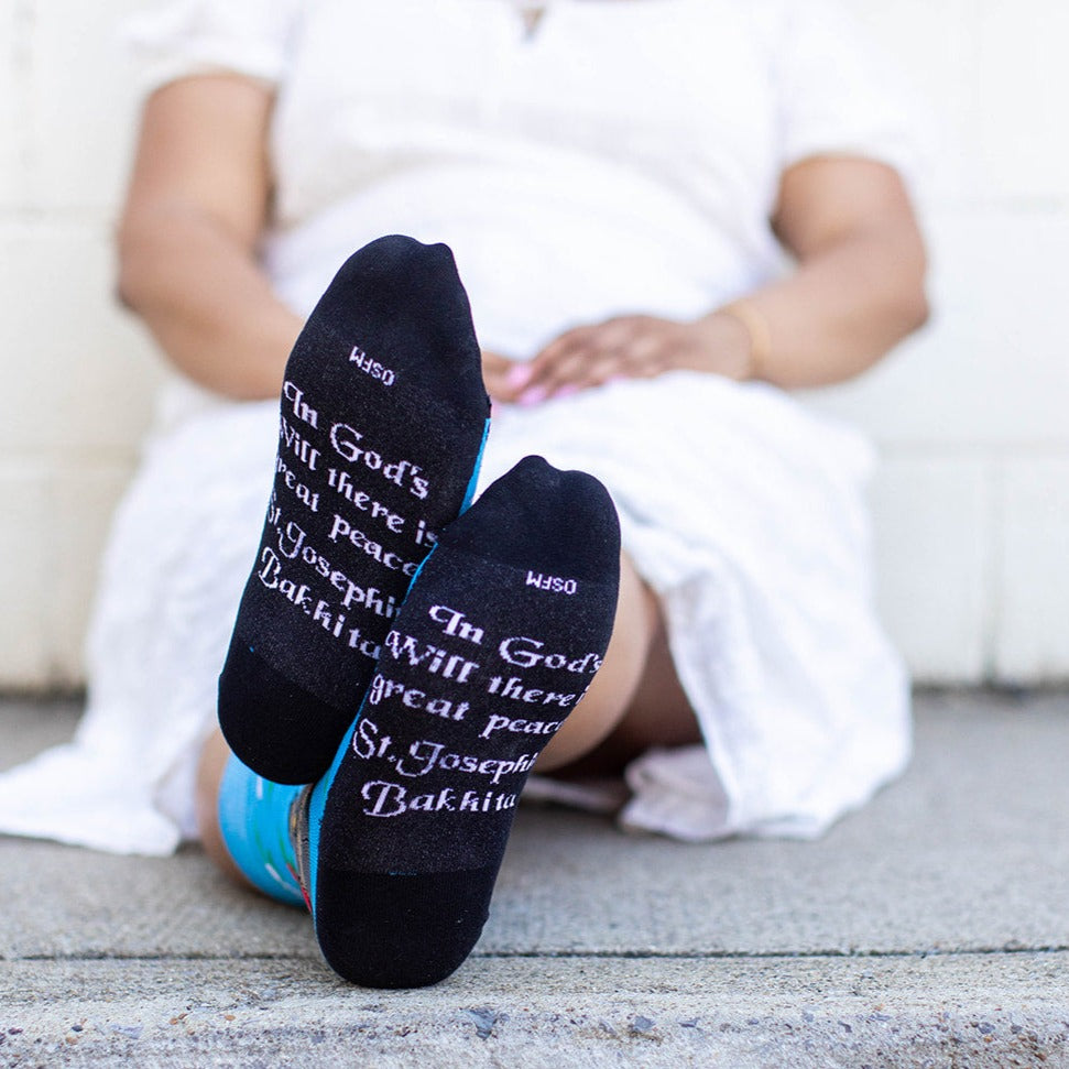 a person sitting on the ground wearing St. Josephine Bakhita Adult Socks