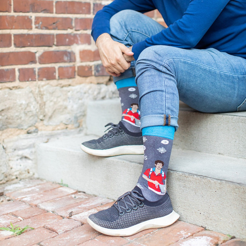 a person sitting on a step with their feet up