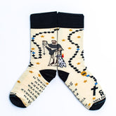 a pair of socks with a picture St. Dominic on it