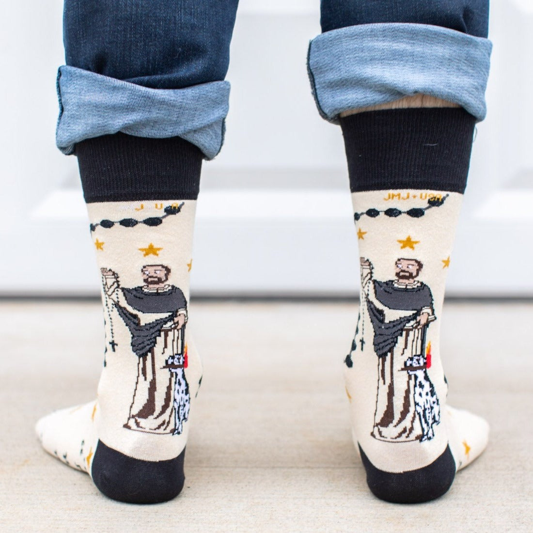 a person wearing a pair of socks with a picture St. Dominic on it