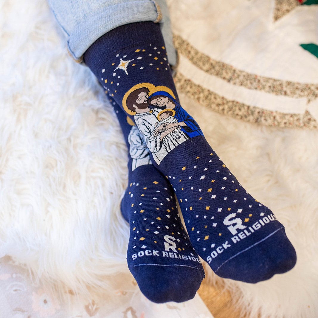 a person wearing a pair of socks with a picture of a man, woman and a baby