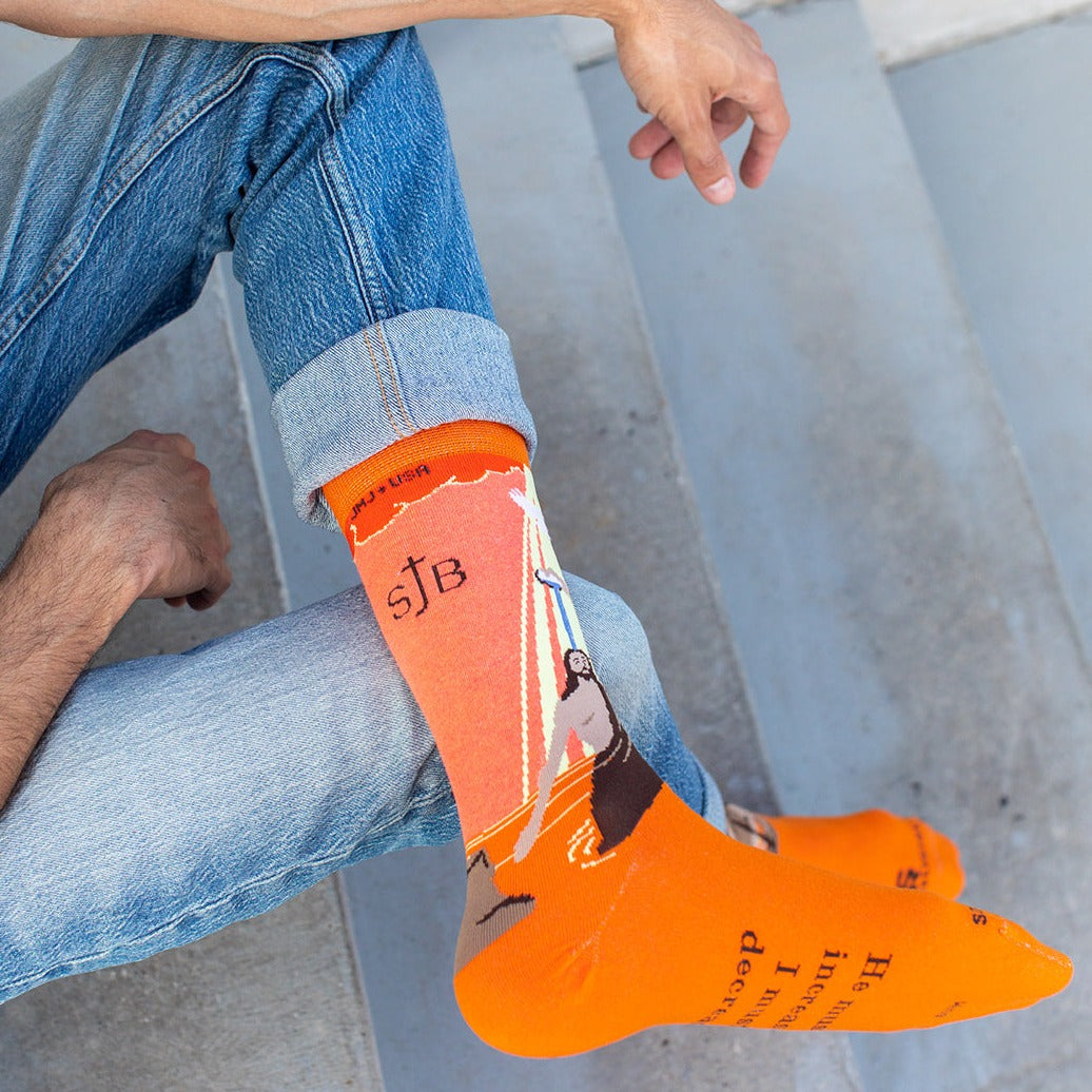 a man is sitting on the steps with his socks on