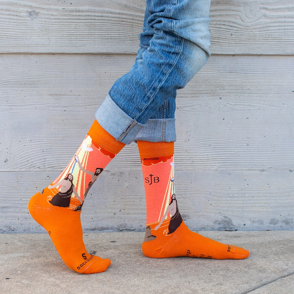 a person wearing orange socks and blue jeans