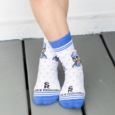 a close up of a child's feet wearing a pair of blue and white socks with a picture of a man wearing a hat