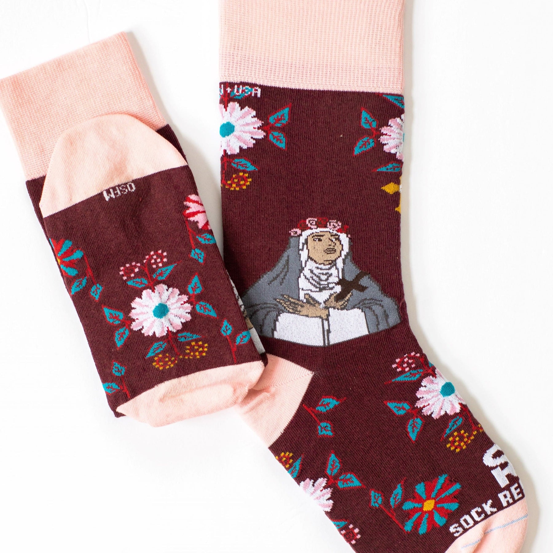 A pair of pink and red sock with a picture of St. Rose of Lima on it