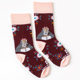 A pair of pink and red sock with a picture of St. Rose of Lima on it