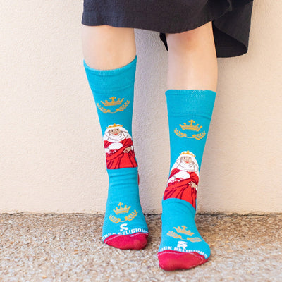 a woman wearing a pair of blue socks with a picture of St. Elizabeth