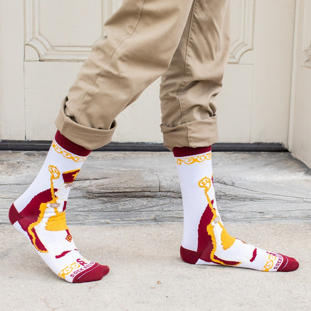 a person wearing a pair of socks with an picture of St. Nicholas
