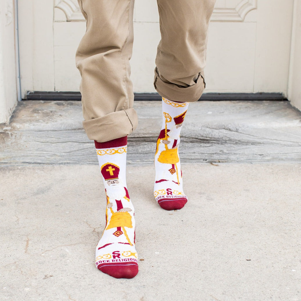 a person wearing a pair of socks with an picture of St. Nicholas