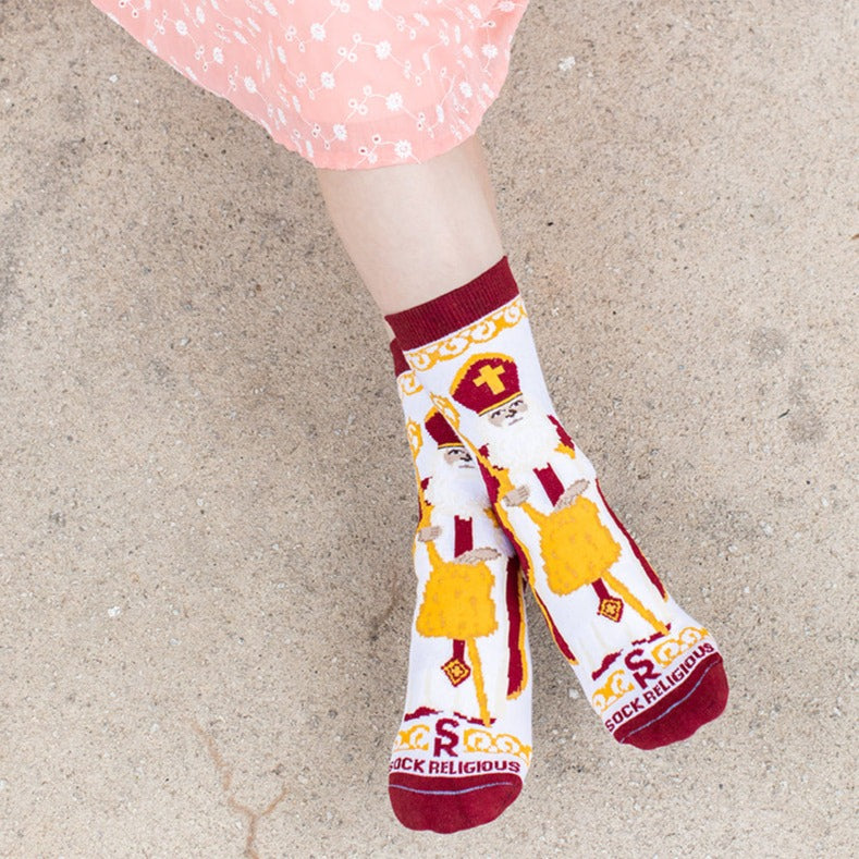 girl wearing white socks featuring large image of St. Nicholas the bishop