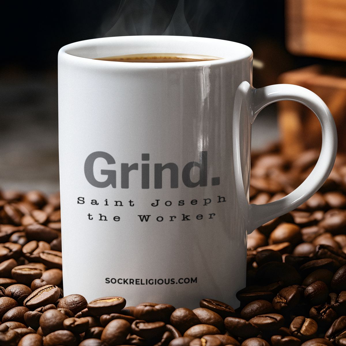 back of mug says "Grind." in large letters, followed by "Saint Joseph the Worker"