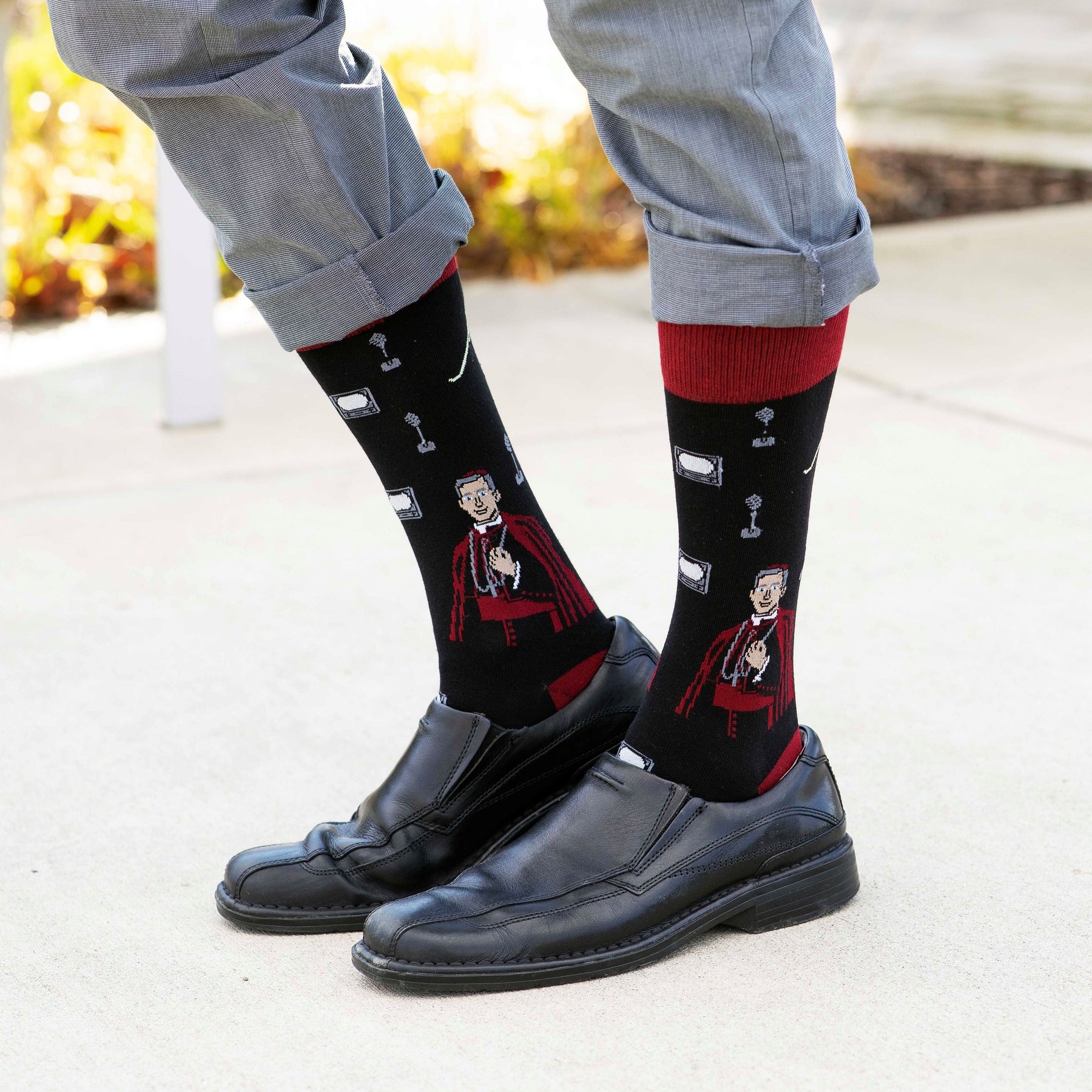 a person wearing a pair of black shoes and socks with a picture of a person on it
