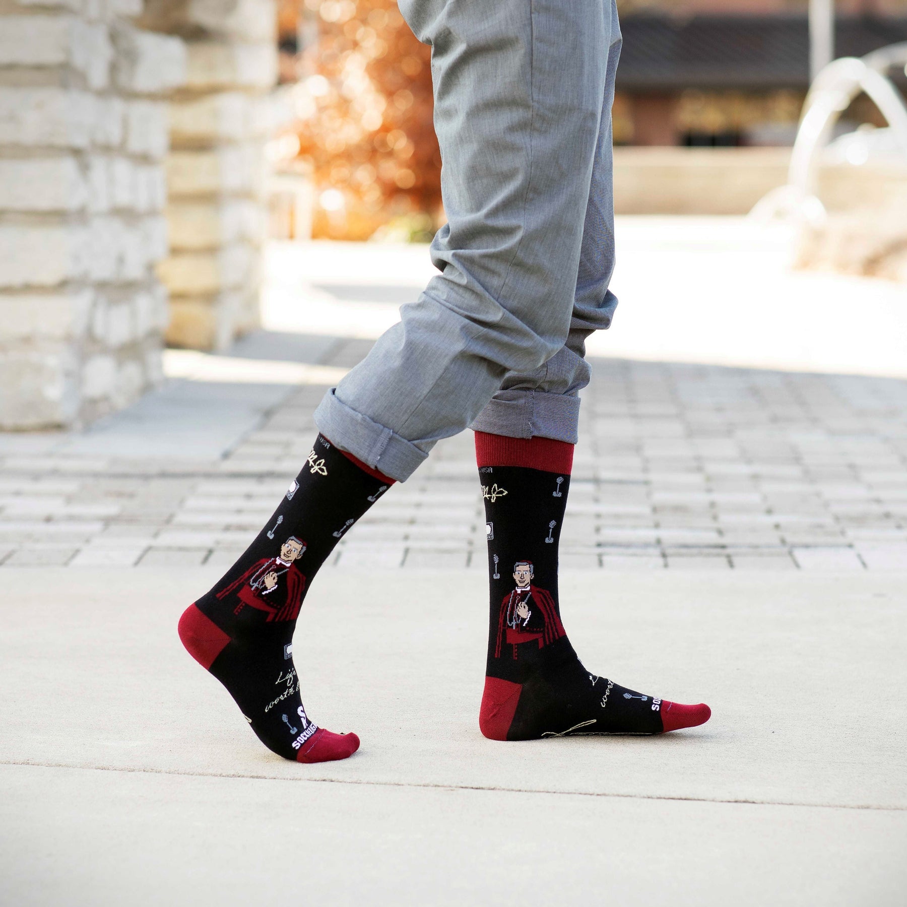 a person wearing a pair of red and black socks