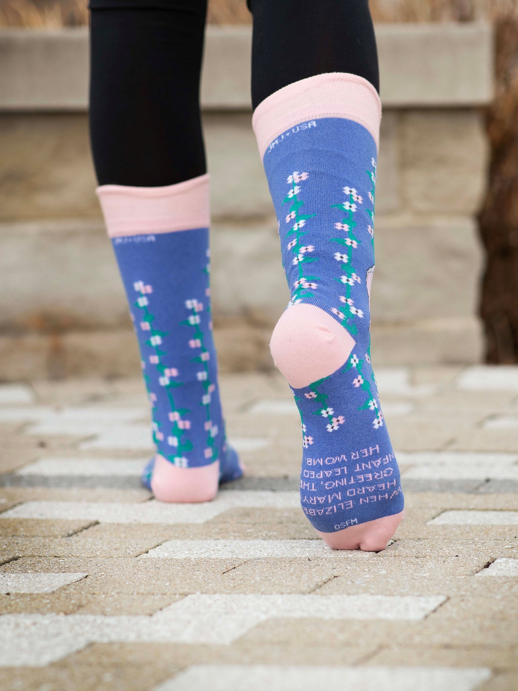 a close up of a person wearing a pair of socks with a picture of Mary and Elizabeth