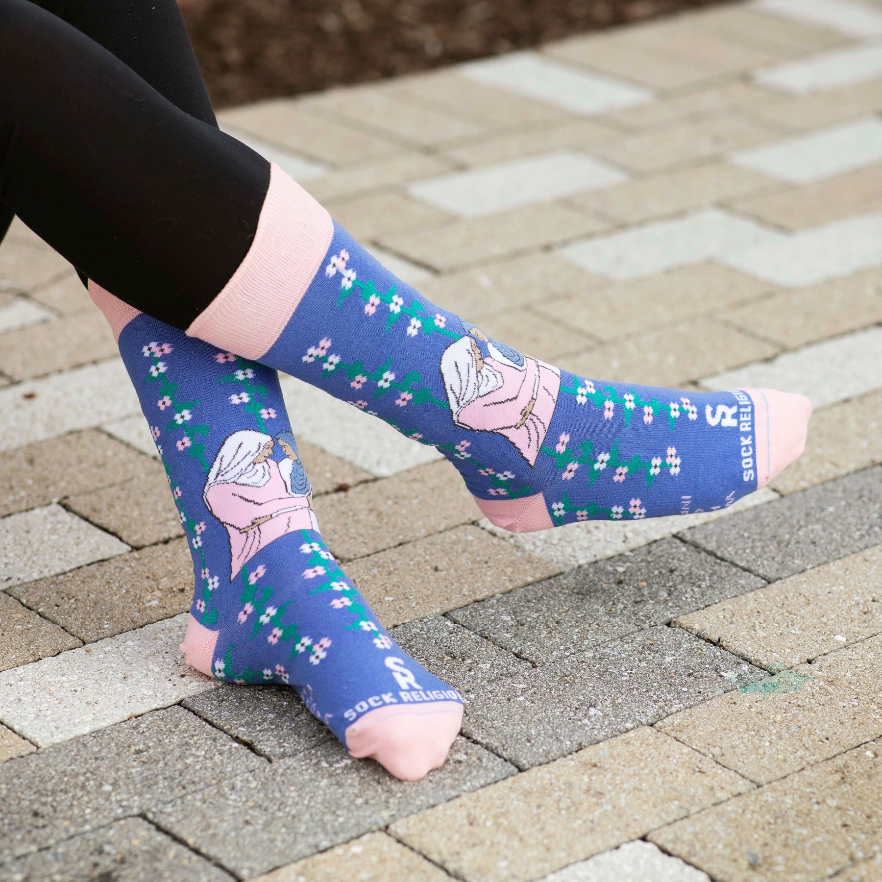 a woman's feet wearing a pair of socks with a picture of Mary and Elizabeth