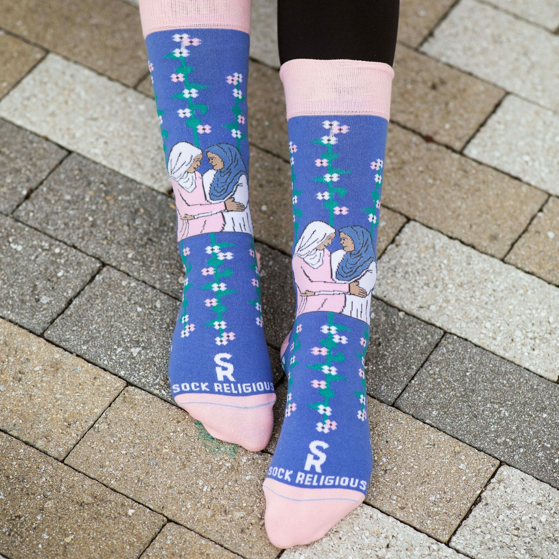 a close up of a person's feet wearing a pair of socks with a picture of Mary and Elizabeth