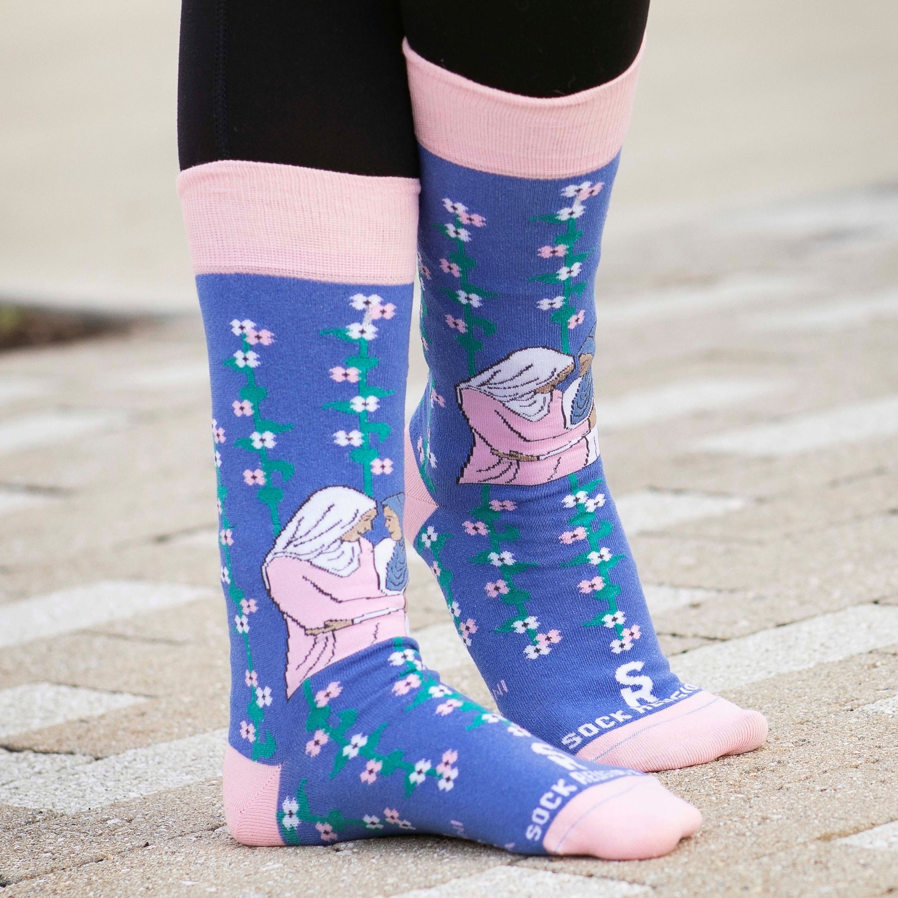 a close up of a person wearing a pair of socks with a picture of Mary and Elizabeth
