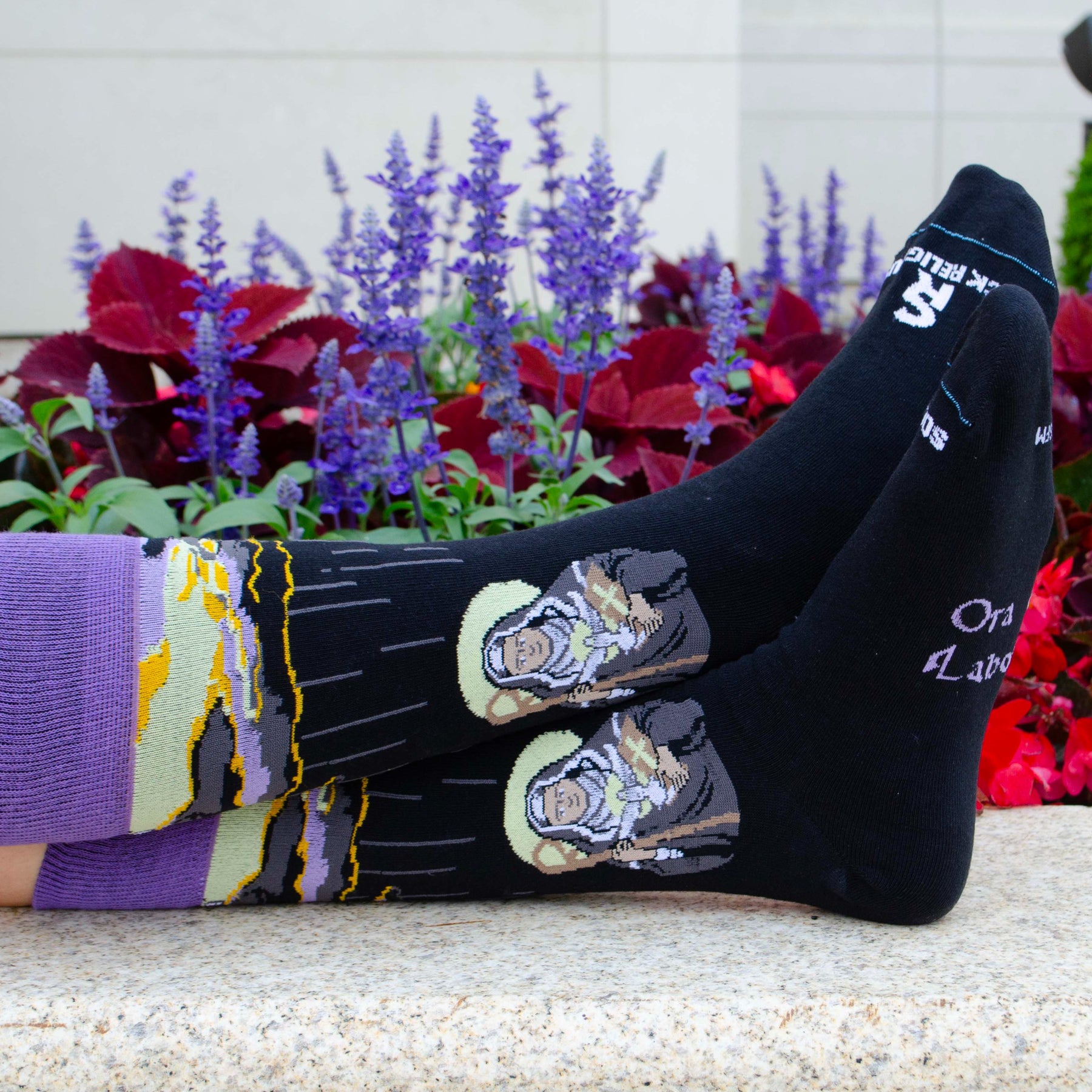 a pair of socks with a picture of St. Scholastica