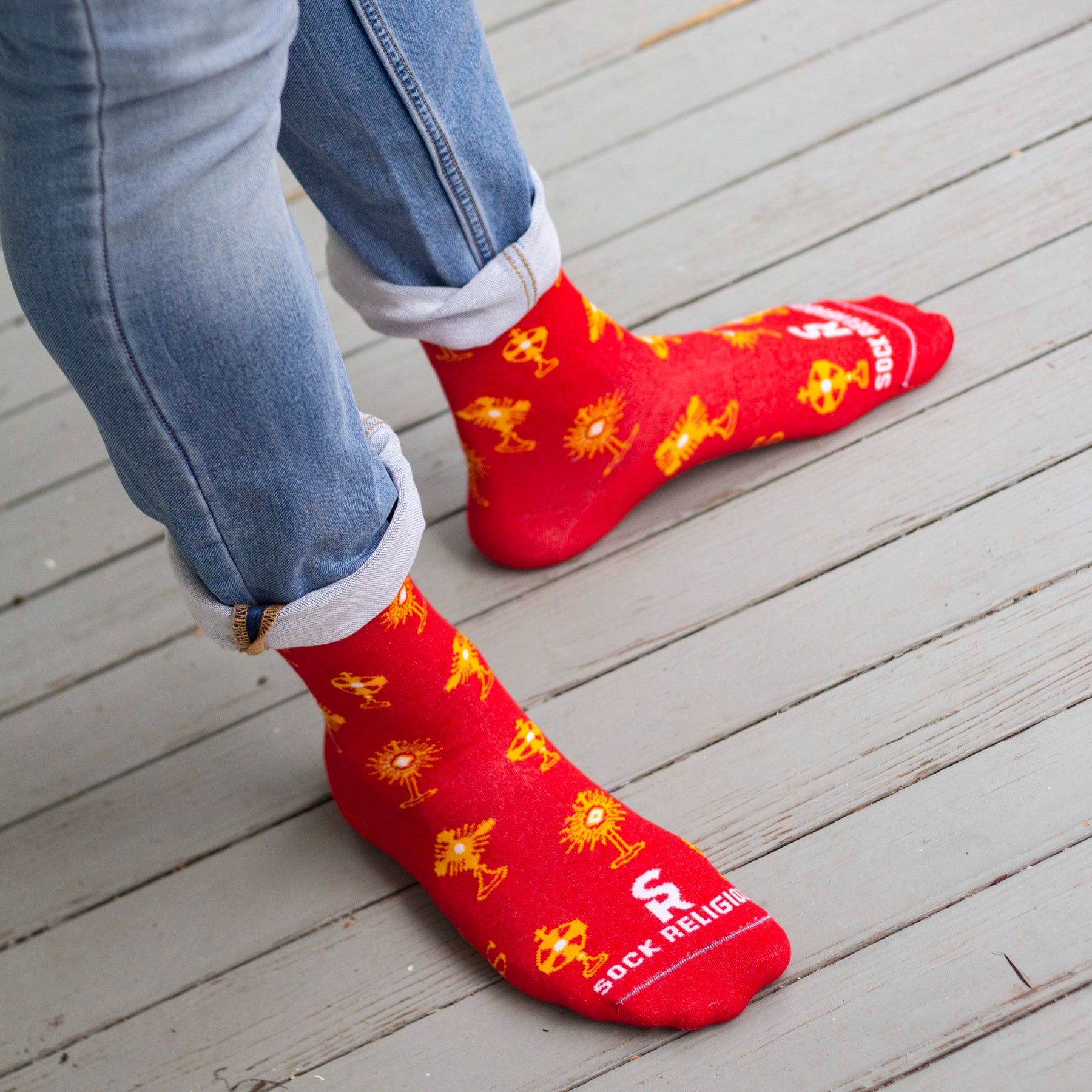 Feet in cheerful red socks with yellow designs