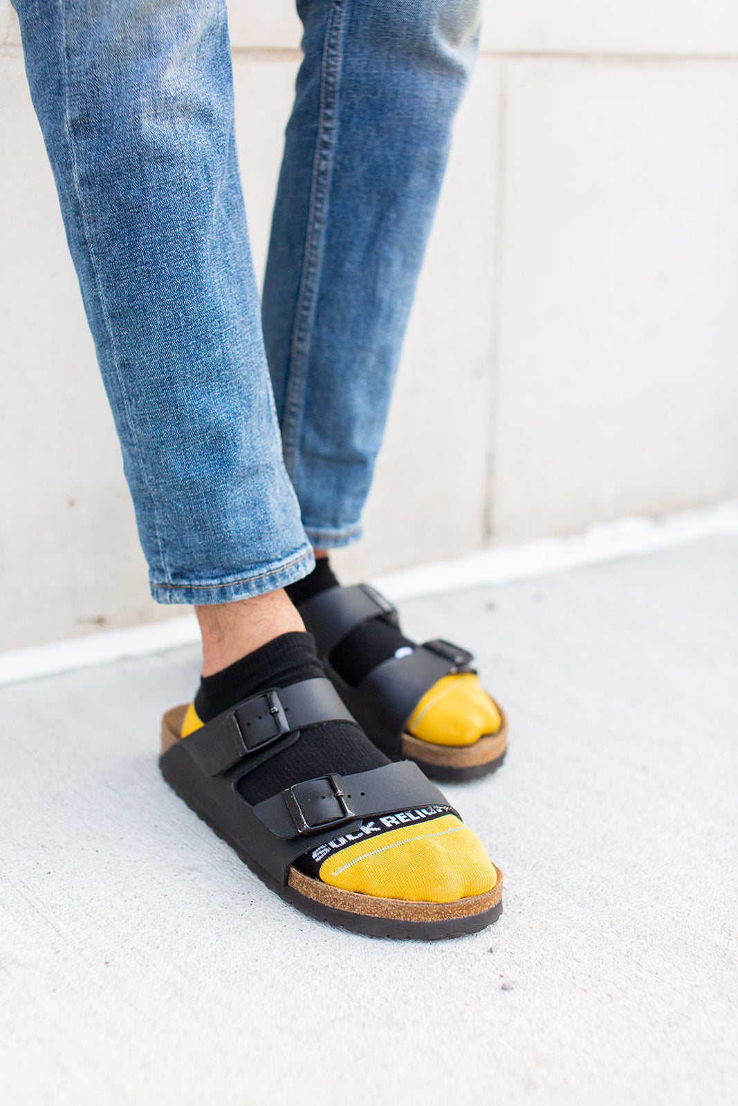 a person wearing a pair of black and yellow socks
