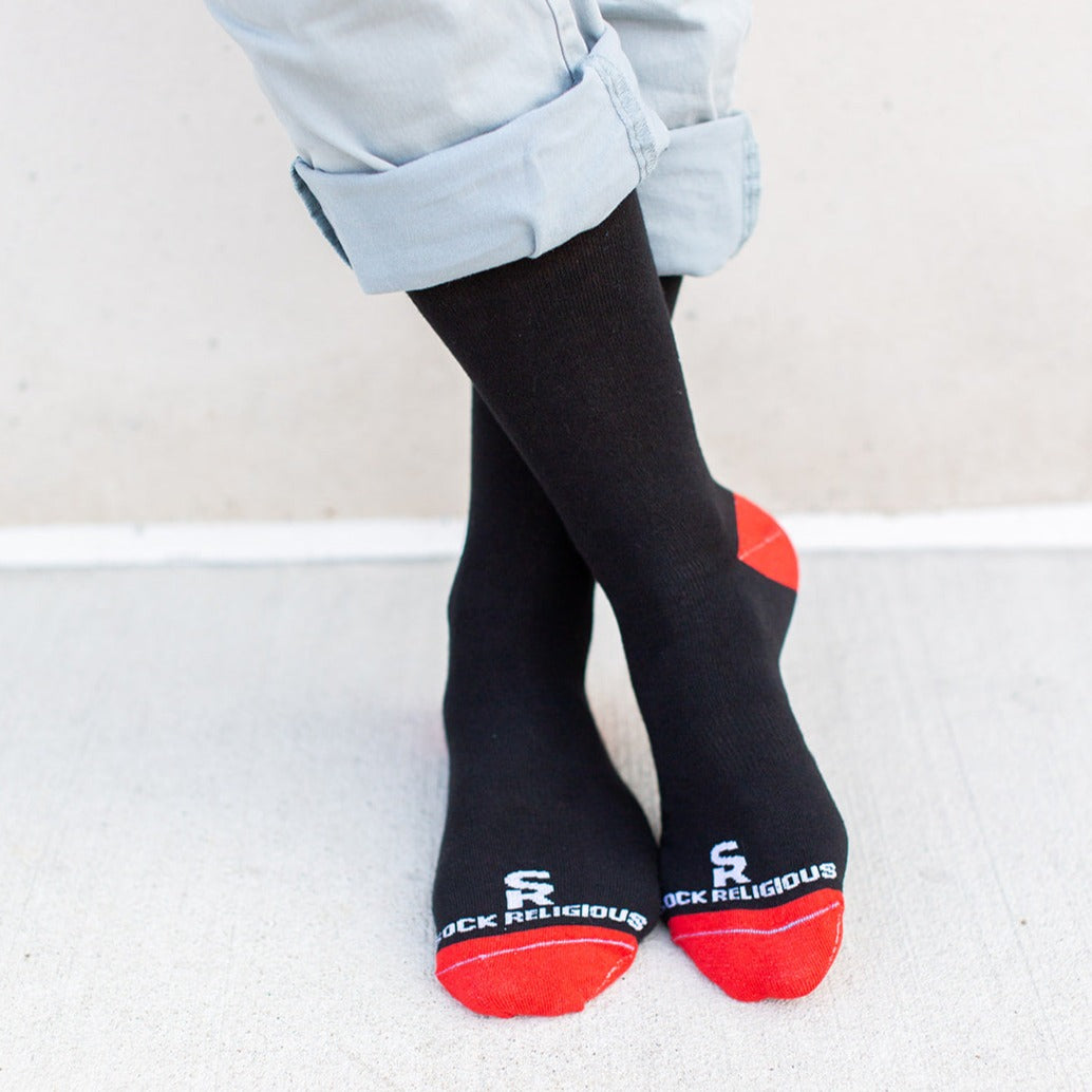 a person wearing black and red socks and red