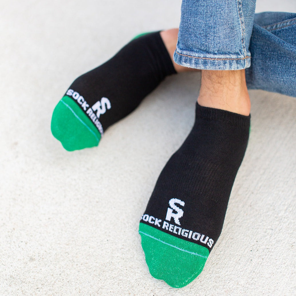 a person wearing black and green socks