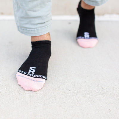 a person wearing black and pink socks