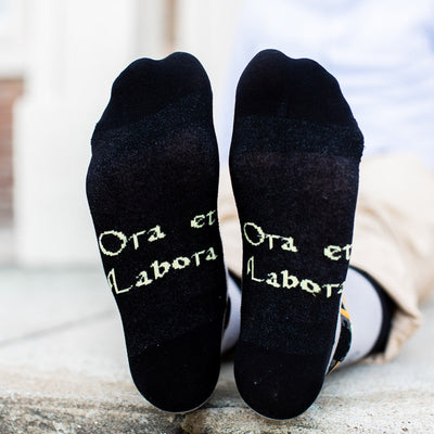 a pair of black socks with words written on them