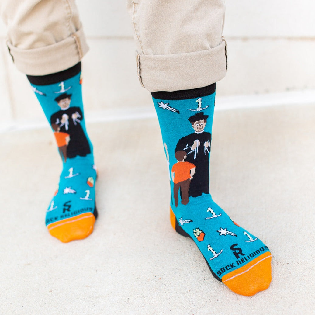 a person wearing a pair of socks with a picture of St. John Bosco