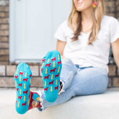 a woman sitting on the ground with her feet up