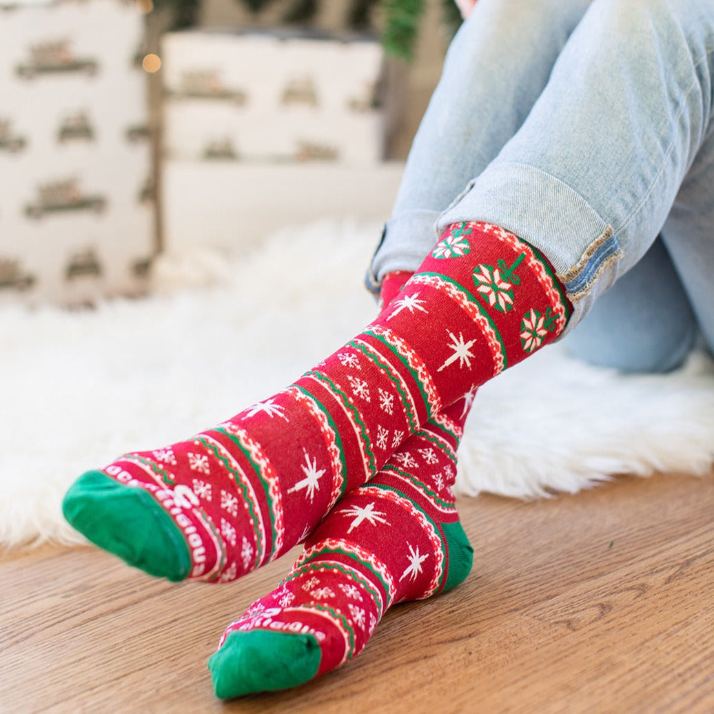 a person sitting on the floor wearing christmas socks
