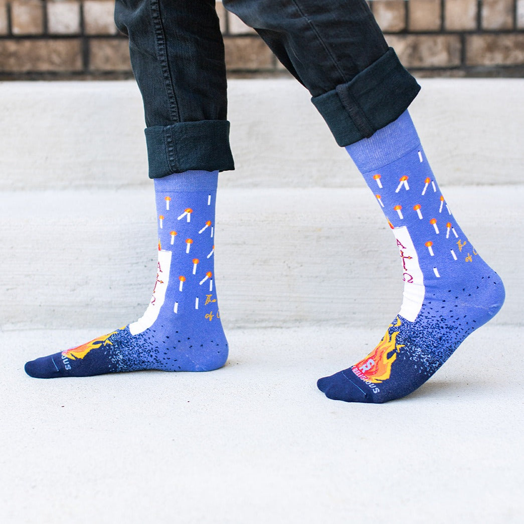 a person wearing a pair of blue socks with candles on them