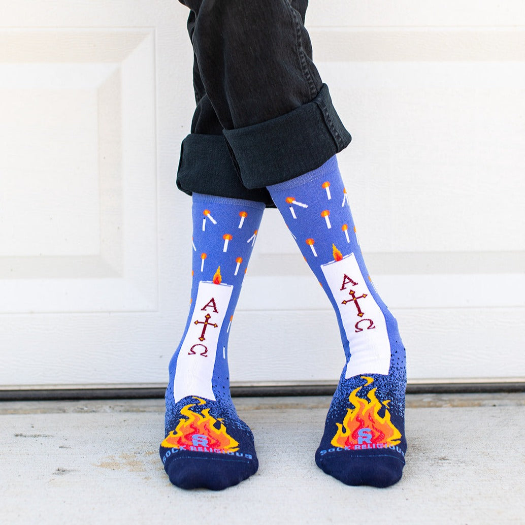 a person wearing a pair of blue socks with candles on them