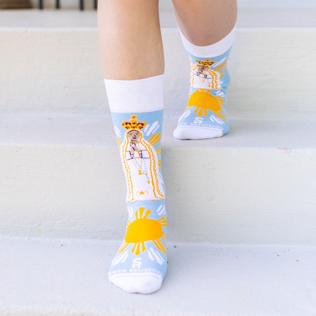 a person wearing a pair of socks with a picture of Our Lady Of Fatima