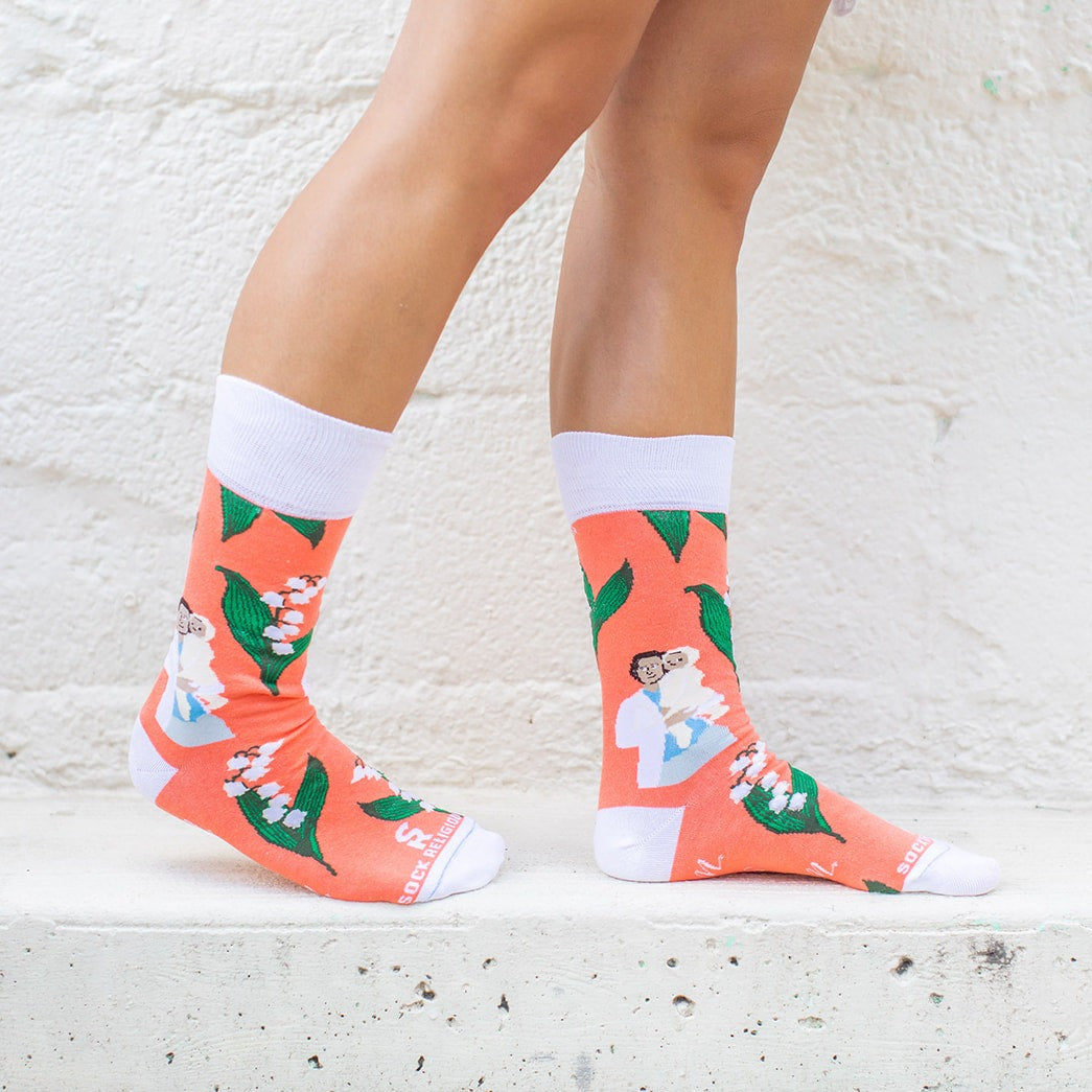 a person wearing a pair of socks with a pricture of St. Gianna Molla