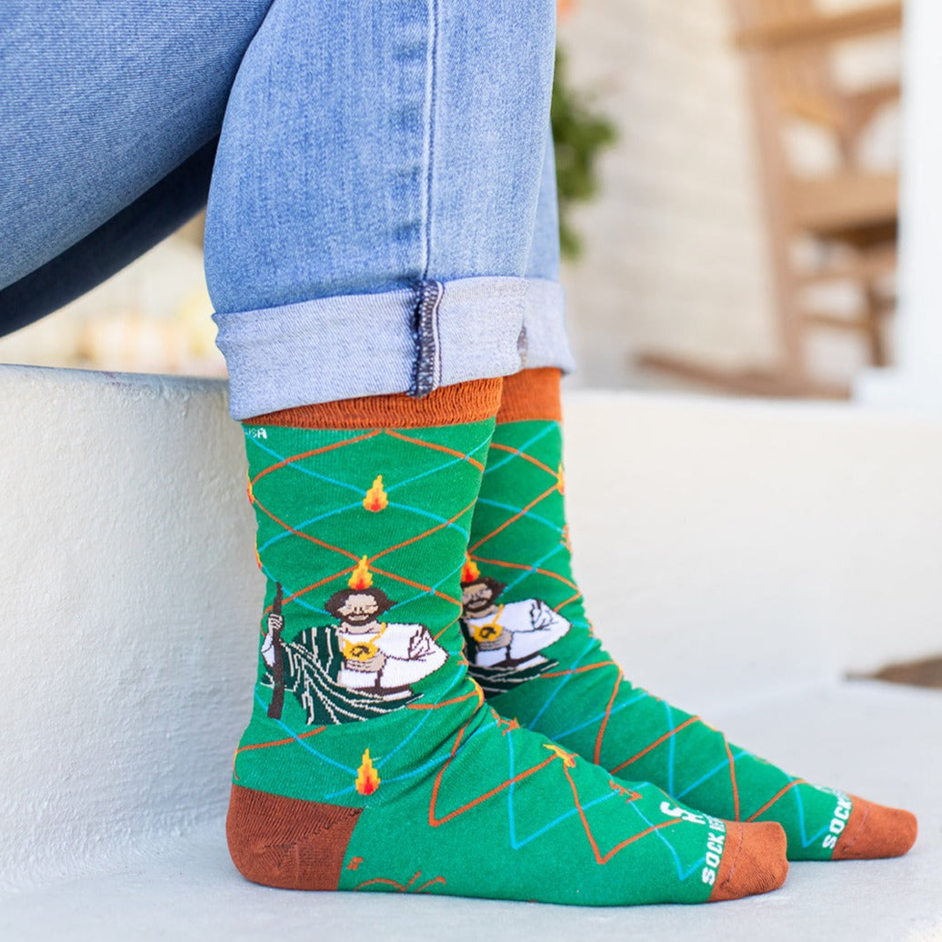 a person wearing a pair of socks with a picture of St. Jude