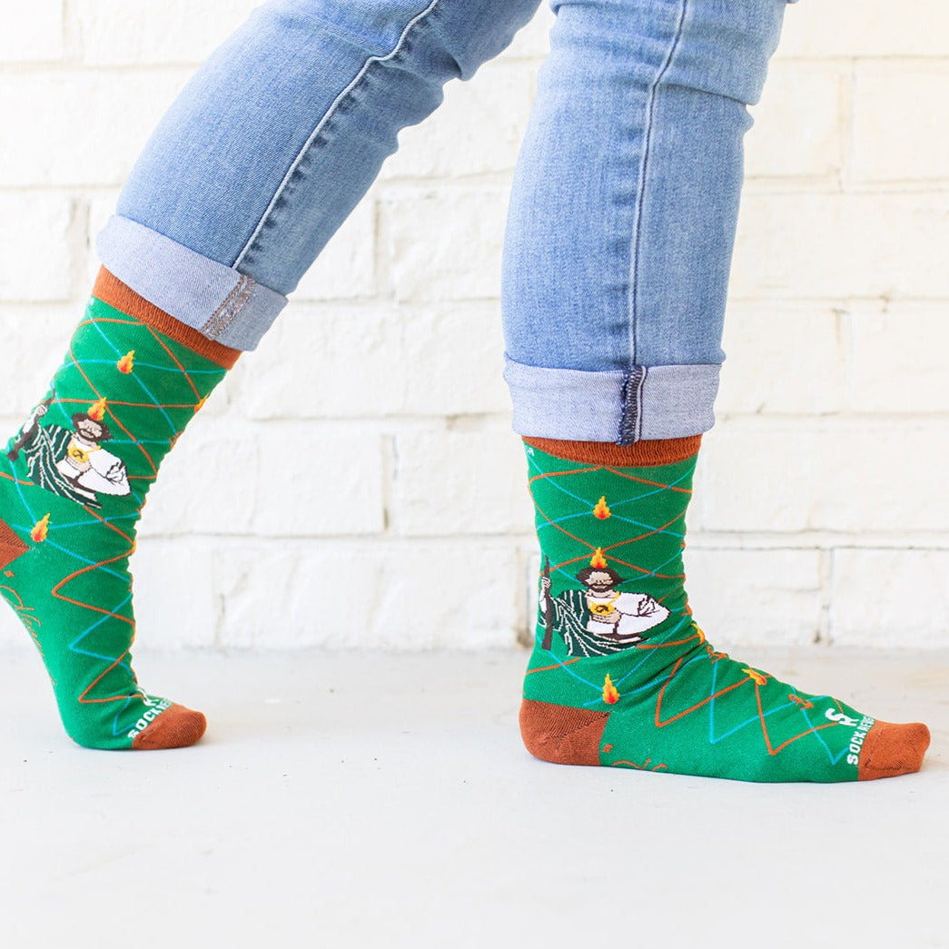 a person wearing a pair of socks with a picture of St. Jude