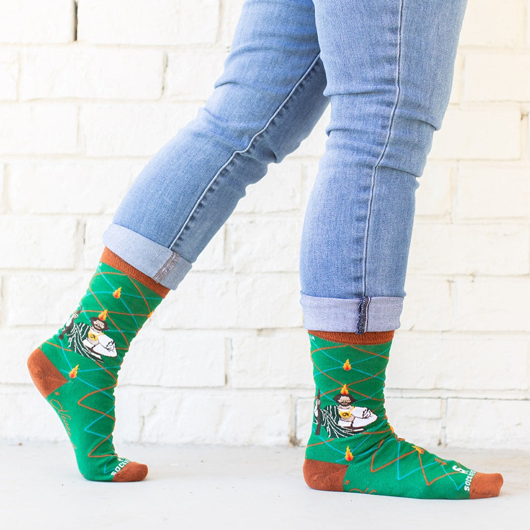a person wearing a pair of socks with a picture of St. Jude