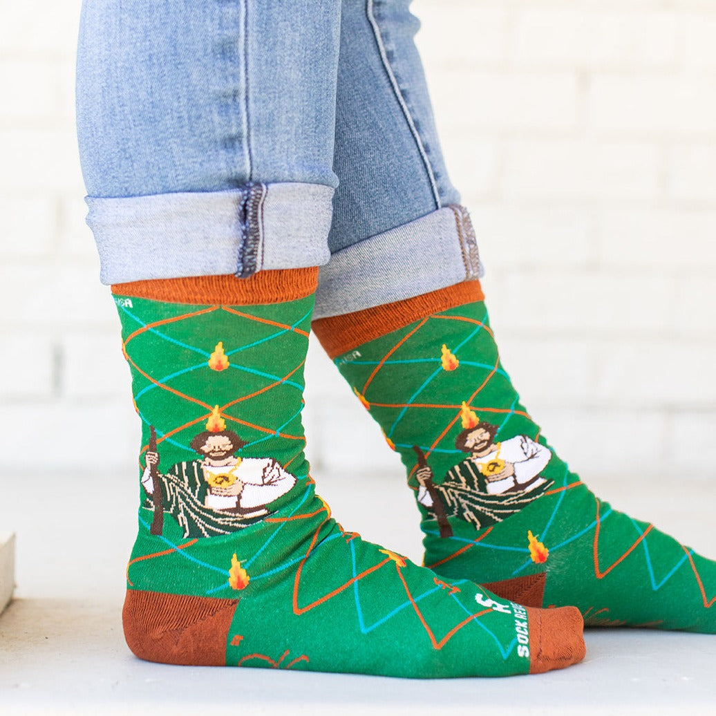 a person wearing a pair of socks with a picture of St. Jude