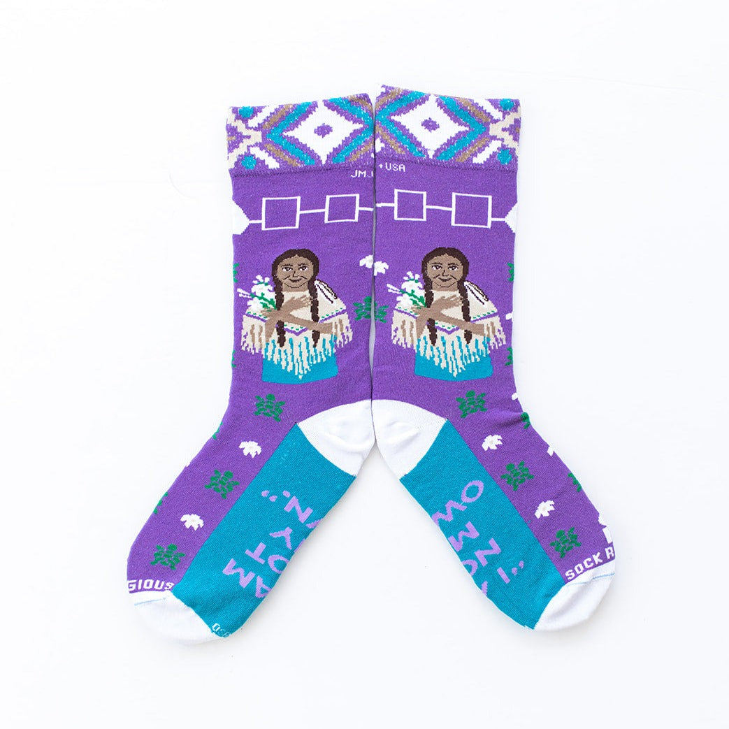 a pair of purple socks with a picture of a woman