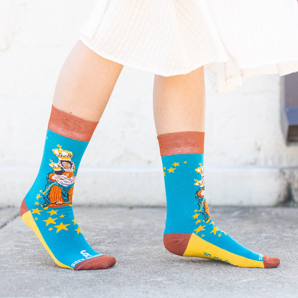 a woman wearing a sock with a picture of Our Lady of La Leche