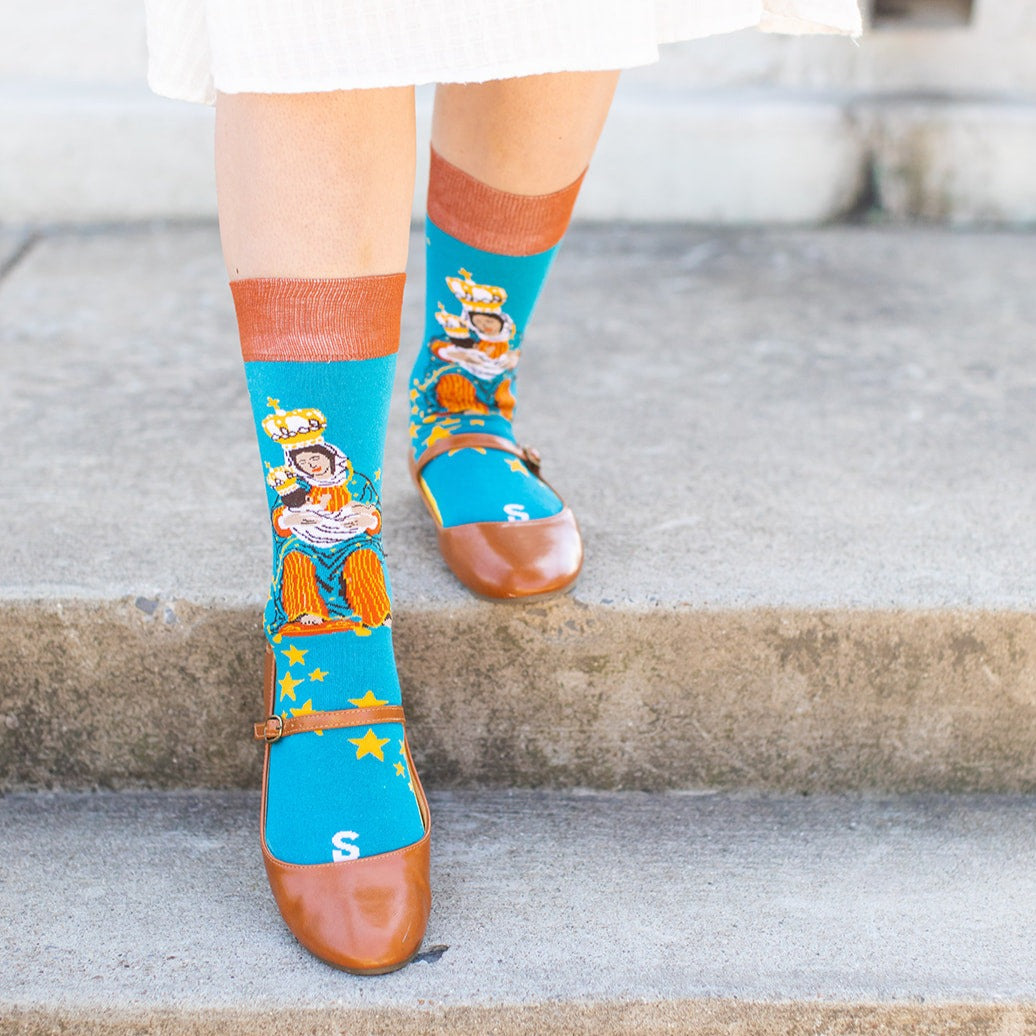 a woman wearing a sock with a picture of Our Lady of La Leche