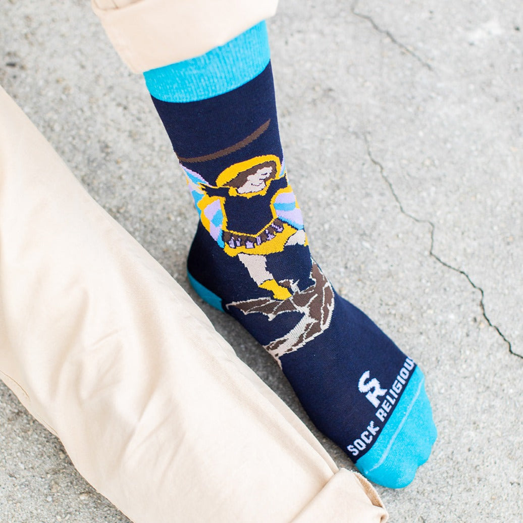 a person sitting down wearing St. Michael socks