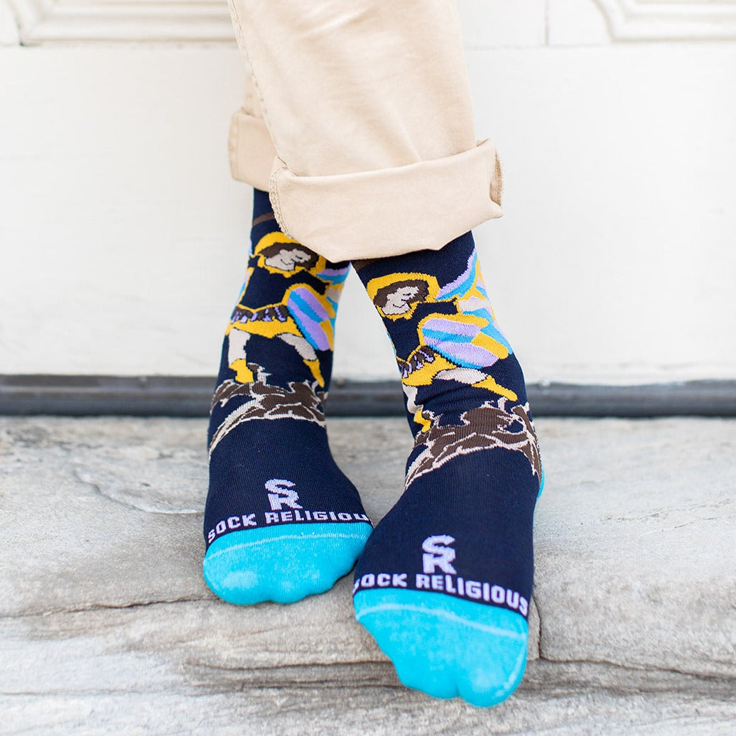 a person standing on a sidewalk wearing St. Michael Sock Religious socks