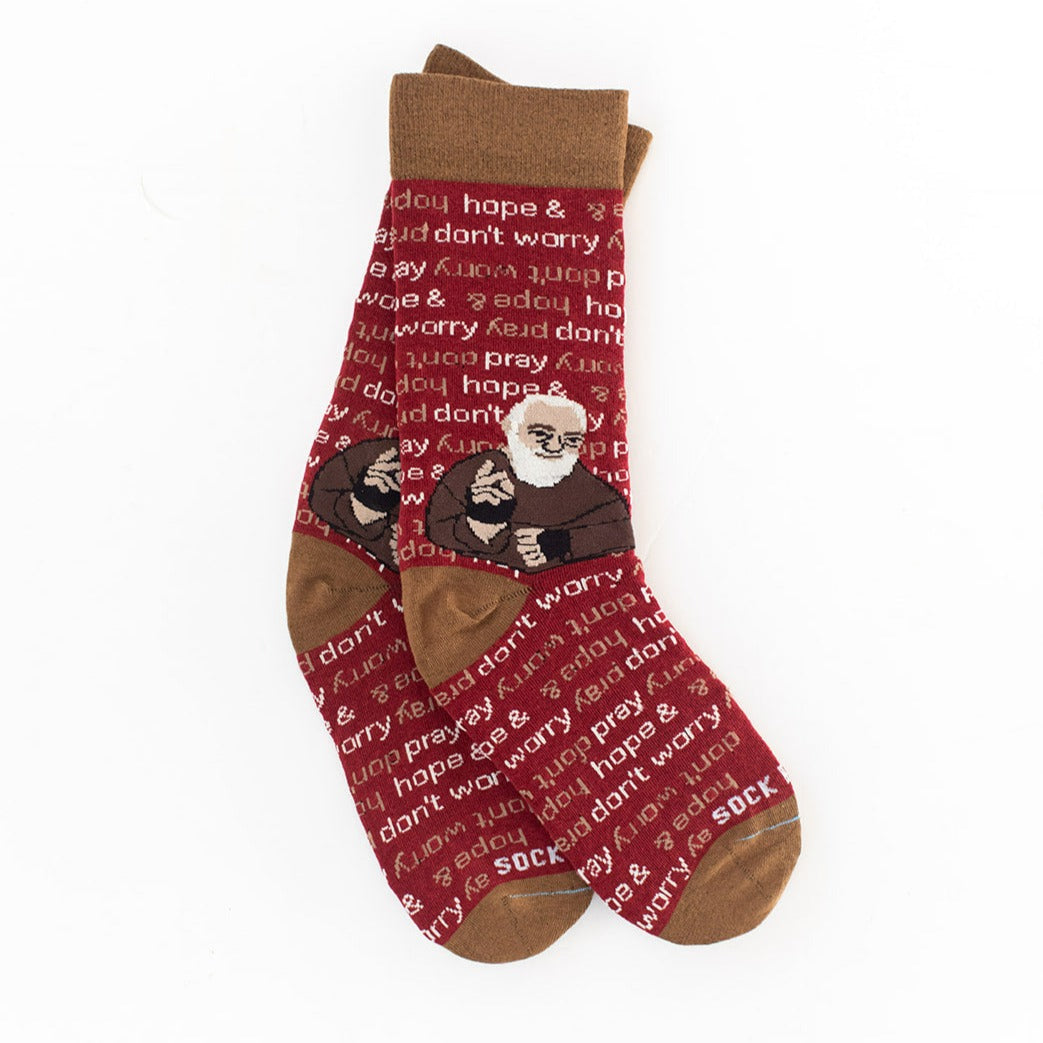maroon and light brown socks that repeat 'pray, hope, and don't worry' in the background and feature St. Padre Pio