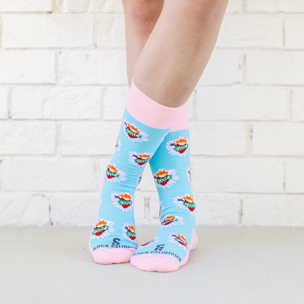 a person wearing a pair of socks with hearts on it
