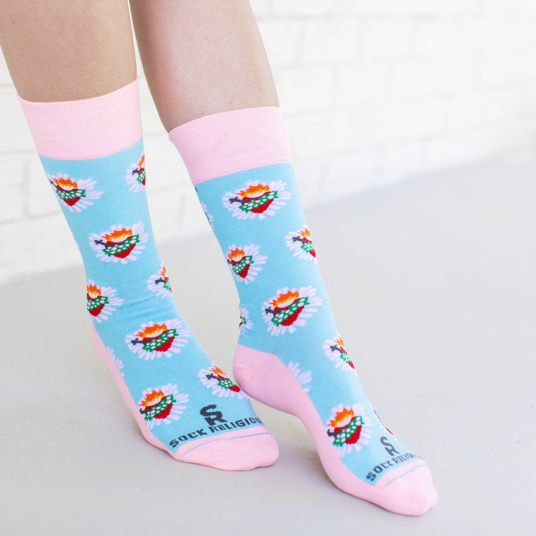 a woman wearing a pair of socks with hearts on it