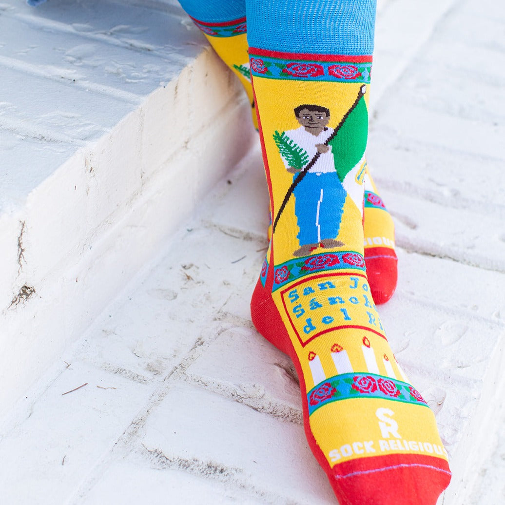 a person sitting on a ledge wearing colorful socks