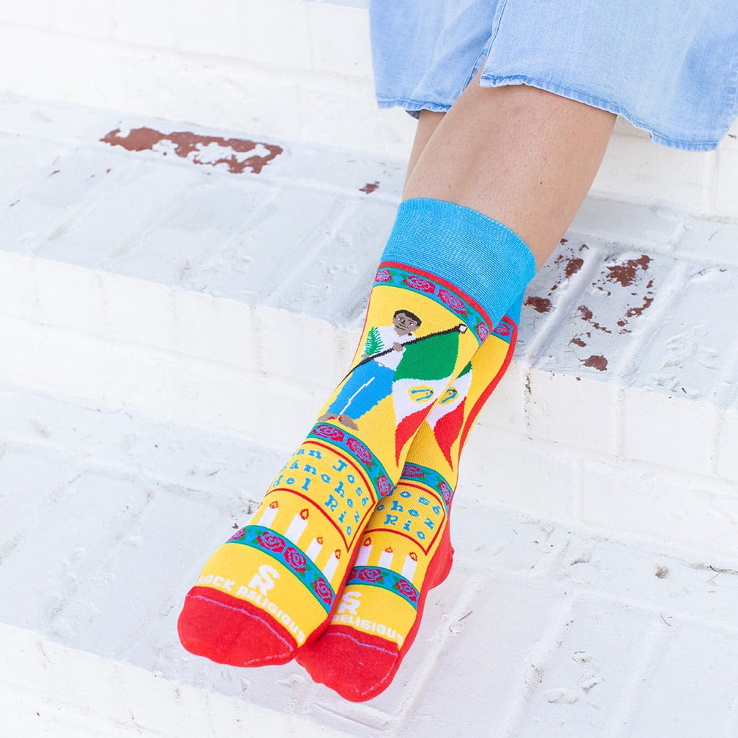 a person wearing colorful socks and blue jeans