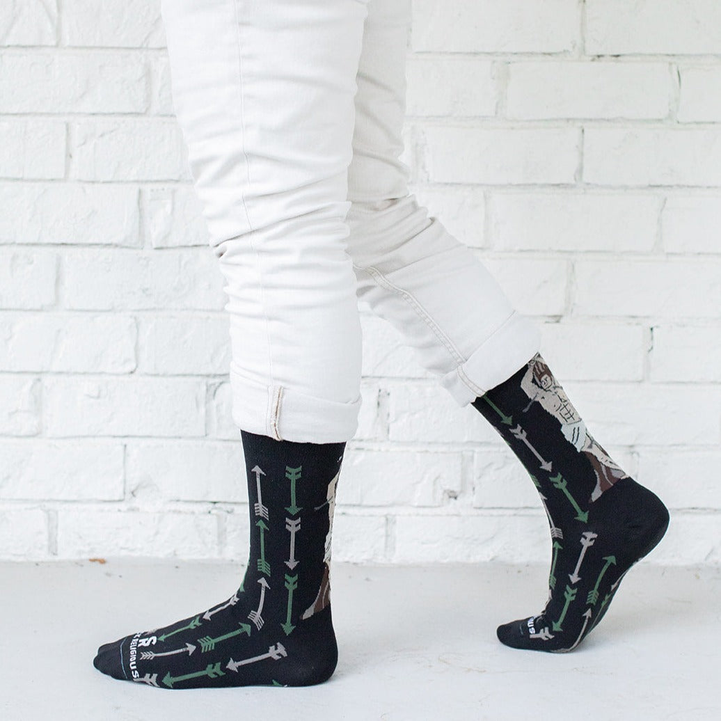 a person wearing white pants and black socks with arrows on it